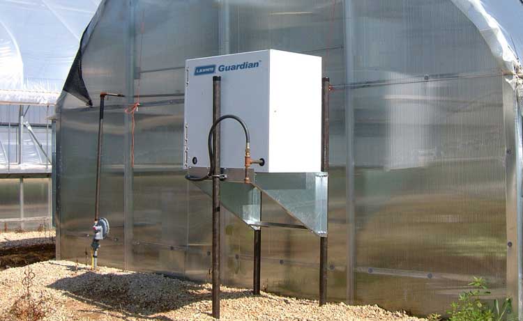 Guardian Forced Air heater mounted outside a greenhouse.